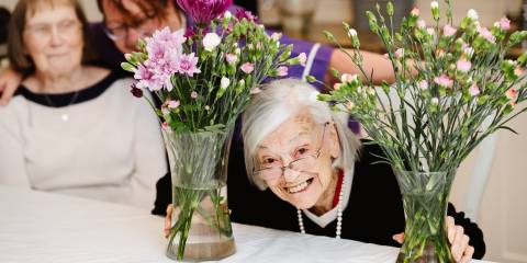 a care home resident undertaking flower arranging