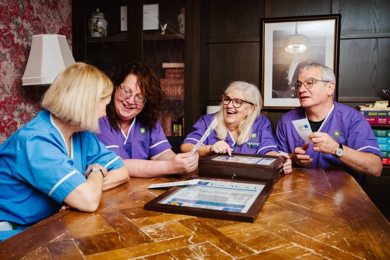 Social care professionals sharing a warm moment