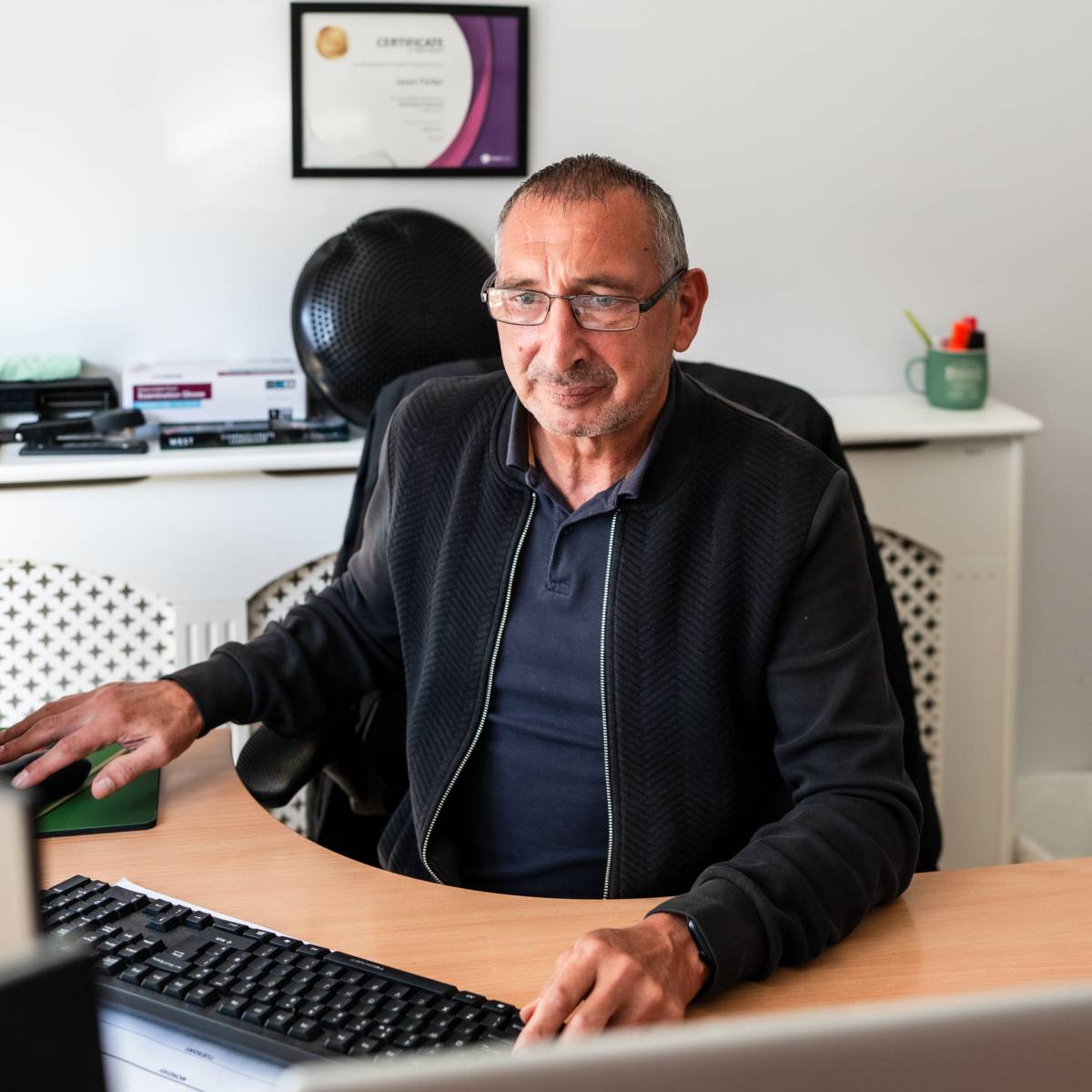 Man on computer in an office room
